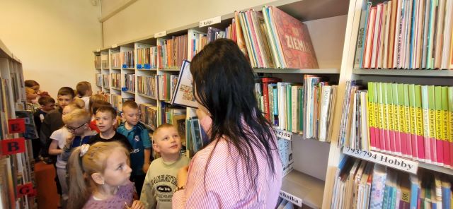 dzieci ogladaja ksiazki w bibliotece